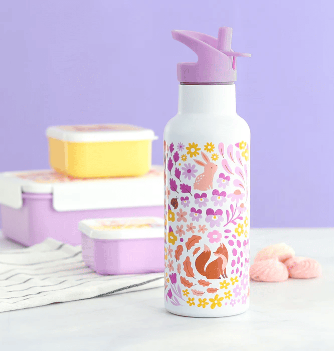 A tall 500 ml lilac-colored stainless steel drink bottle decorated with a cheerful floral pattern in pink, yellow, and purple, interspersed with small fox motifs. It has a matching lilac flip-up sports cap with a straw spout and a carry loop.