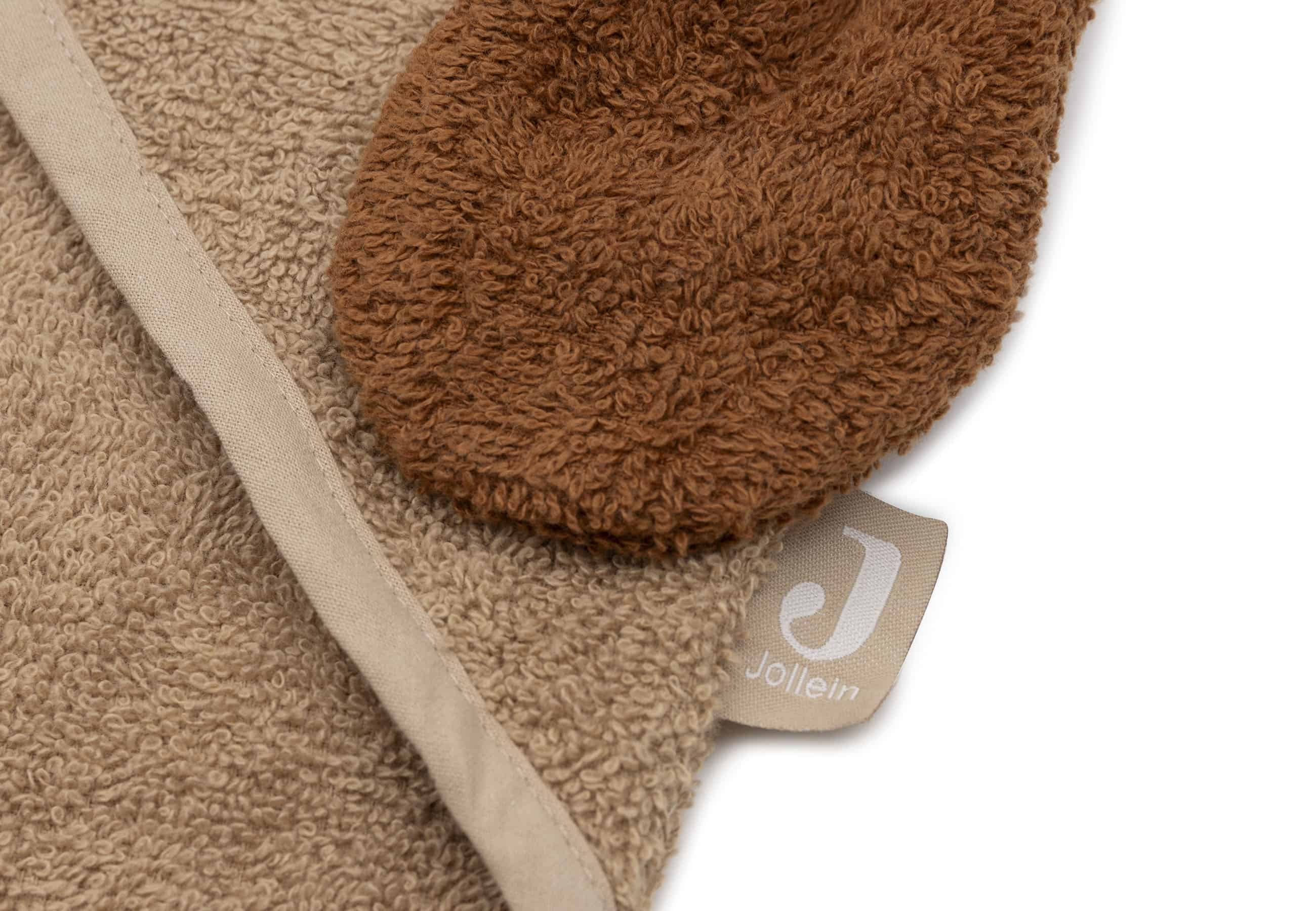 Detail of the fabric texture and stitching near the hood corner, highlighting the terry cloth material and embroidery work.