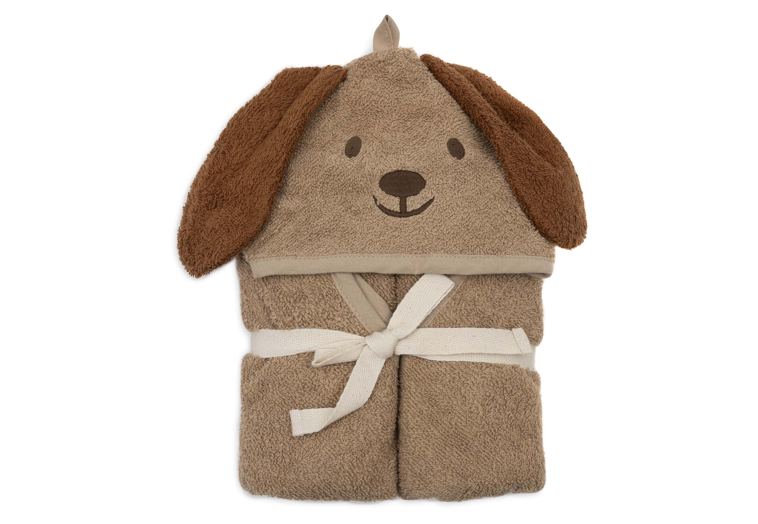 A hooded baby bath cape in light brown terry cloth, with a dog’s face embroidered on the hood and floppy, darker brown ears attached.